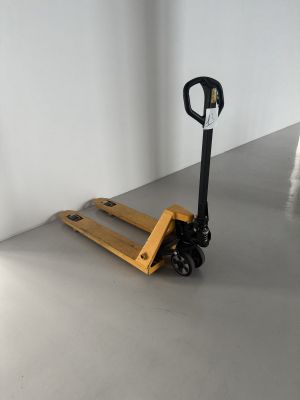 a small wooden pallet sitting on the floor next to a white wall