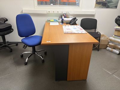 a desk with a chair and a computer on it