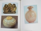 an open book with a picture of a vase and other items in it