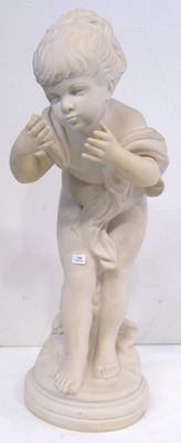 a small statue of a boy holding something in his hands