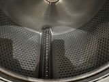 a close up view of a washing machine with the door open