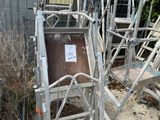 a metal cart that is sitting in the middle of a yard
