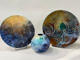 three pieces of art that are sitting on a table