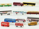 a lot of toy buses on display on a clear shelf