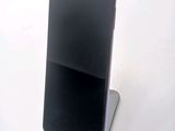 a phone that is sitting on a stand on a table