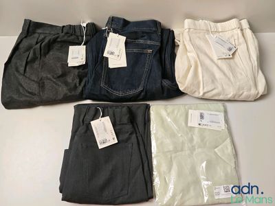 four pairs of men ' s pants are lined up on a table