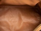 the inside of a brown leather purse with a zipper on it
