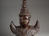 a bronze statue of a woman with a crown on her head