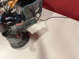 someone is using a sander to polish the surface of a table