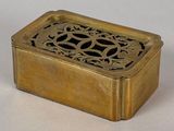 a small brass box with a decorative design on it