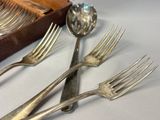 four forks and two spoons sitting on a table