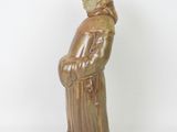 figurine of a man in a brown coat and hat