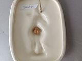 porcelain figurine of a woman holding a flower in a bowl