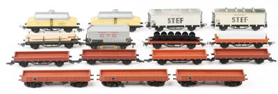 several toy trains are lined up in a row on a white surface