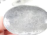 a person holding a silver spoon in their hand
