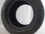 tire on a white surface with a white curtain in the background