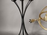 two metal candlesticks that are standing next to each other