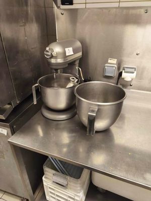 two bowls and a mixer on the counter in the kitchen