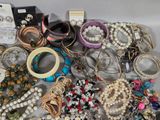many different bracelets and bracelets on the table