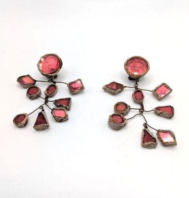pair of pink and silver earrings on a white surface