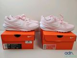 a pair of pink shoes are sitting on top of a box