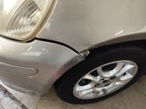 a close up of a car ' s front tire with a denting on it
