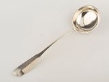 a silver spoon with a spoon handle on a white surface