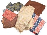 many different types of scarves laid out on a white surface