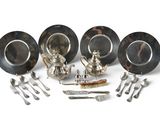 a group of silver plate and silverware on a white surface