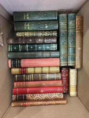 a box full of old books sitting on the floor