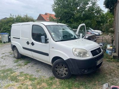 a white van parked in a yard next to a building