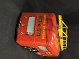 a toy fire truck that is sitting on a black surface