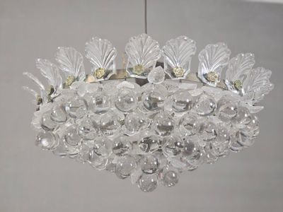 a glass chandelier hanging from a ceiling in a room
