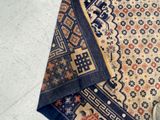 a person standing next to a rug on the floor