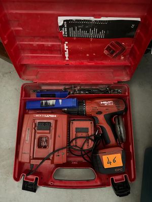 a red tool box with tools in it on the floor