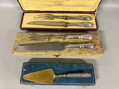 three pieces of silverware are in a case on a table