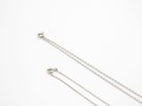silver plated chain with a heart pendant on a white background