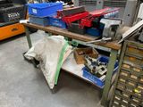 many different types of tools on a workbench in a warehouse