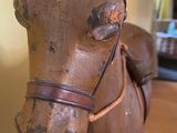 a wooden horse that is sitting on a table