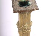 a gold candle holder that has a hole in it