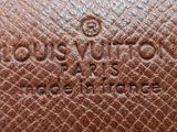 a close up of a louis vuitto bag on a table