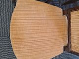 two wooden chairs sitting next to each other on a carpeted floor