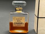 a bottle of perfume sitting on a table next to a box