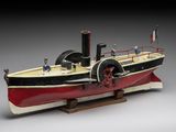 a model of a steam powered boat on a wooden stand