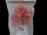a bag with a pink flower in it on a black background
