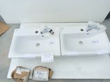 two white sinks sitting on top of a white counter