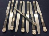 several knives are lined up on a blue surface with a knife in the middle