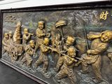 a large metal plaque with a group of people on it