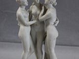 three figurines that are standing on a table