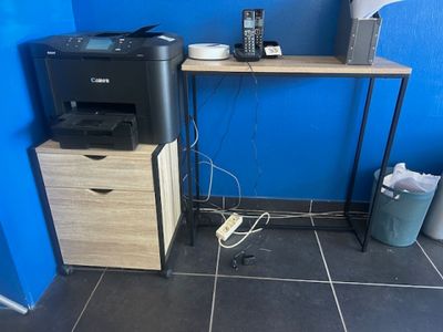 a desk with a printer and a printer on it